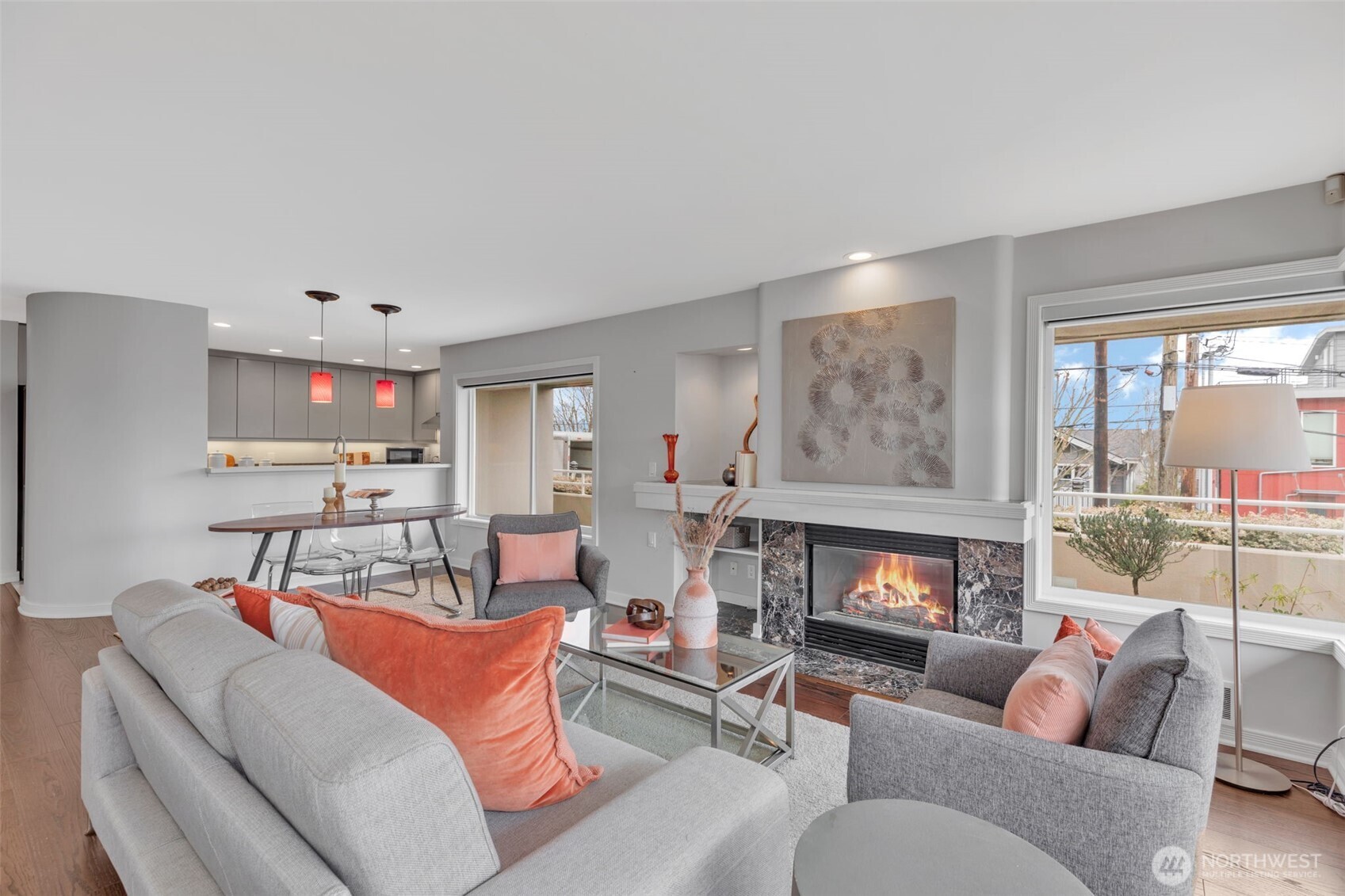 1231 5th Avenue North, Unit 101 Seattle, WA 98109 - Photo 6 of 31 a living room with furniture a fireplace and a large window