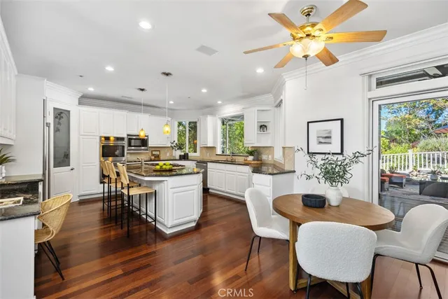a kitchen with a dining table chairs and view kitchen