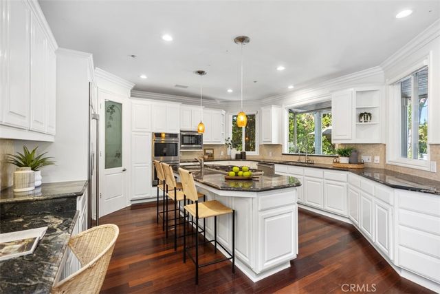 a kitchen with a table chairs stove and cabinets