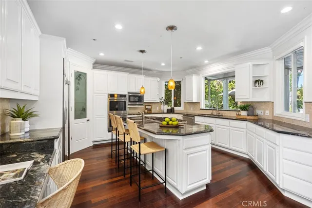 a kitchen with a table chairs stove and cabinets