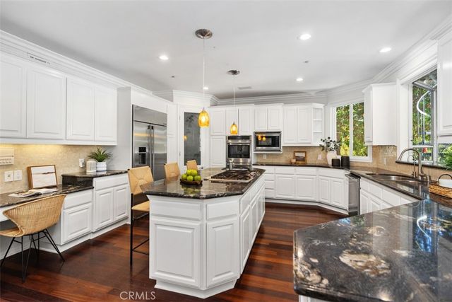 a kitchen with sink stove and cabinets