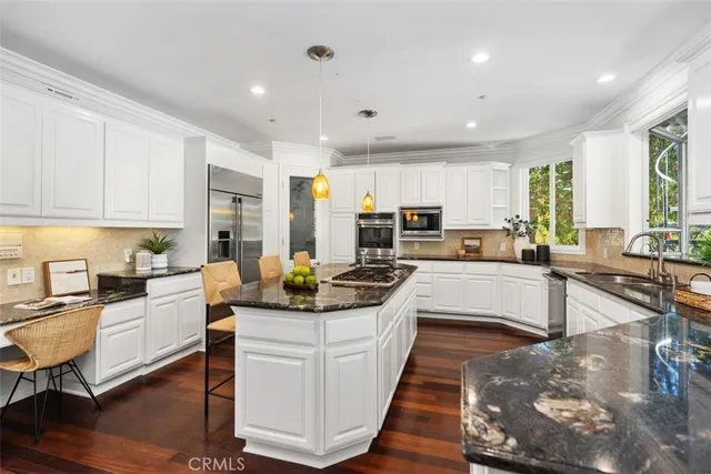 a kitchen with sink stove and cabinets