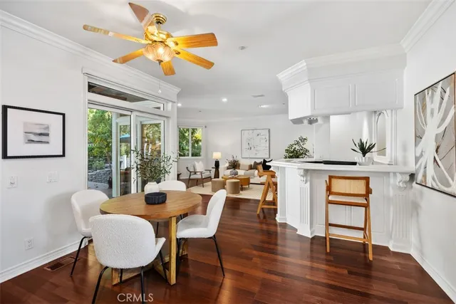a dining room with furniture a window and wooden floor