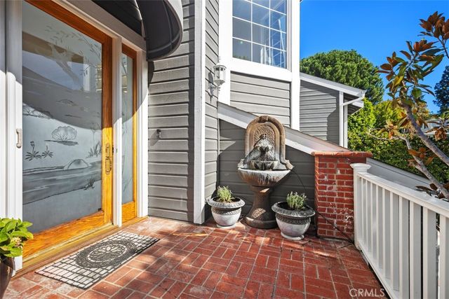 a view of a balcony with chairs and potted plants