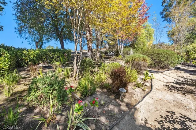 a view of a green field with wooden fence