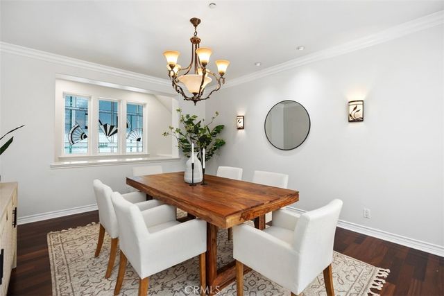 a dining room with a wooden table and chairs