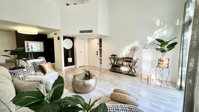 a living room with furniture and a potted plant