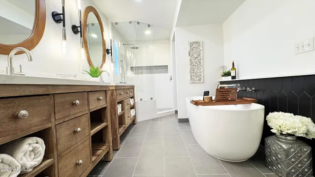 a bathroom with a bathtub sink and mirror