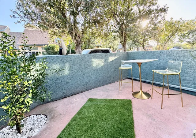 a view of a backyard with sitting area