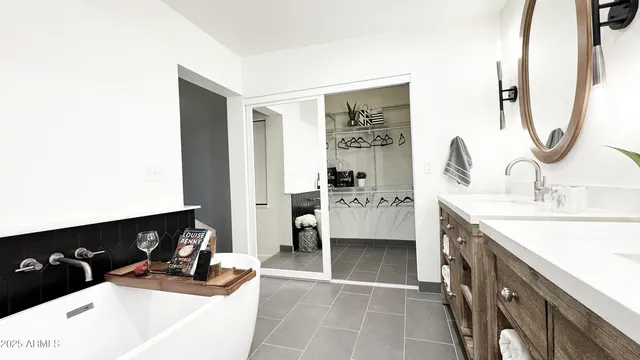 a view of a room with a potted plant a chandelier and wooden floor