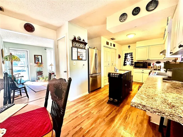 a living room with lots of furniture and a wooden floor