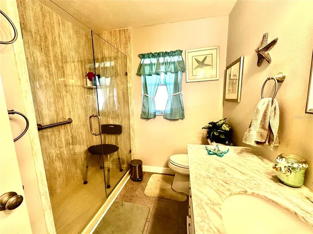 a bathroom with a tub sink and mirror