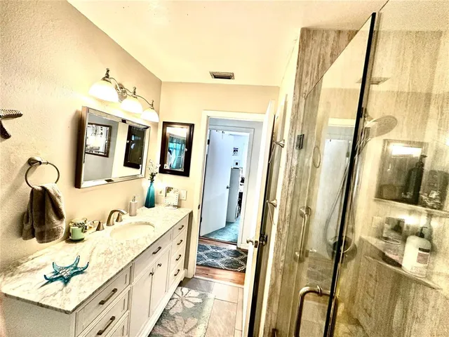 a bathroom with a tub sink and mirror