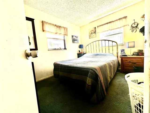 a bedroom with a bed and a table