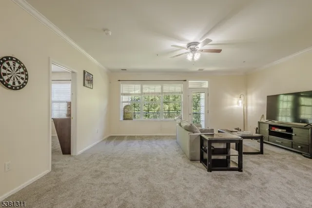 a view of a livingroom with furniture and a flat screen tv