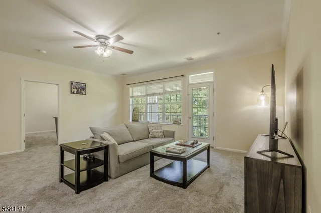 a living room with furniture and a chandelier