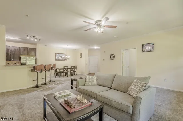 a living room with furniture and kitchen view