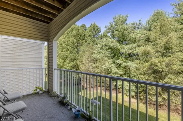 a view of a balcony with chair and wooden fence