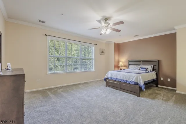 a spacious bedroom with a bed and window
