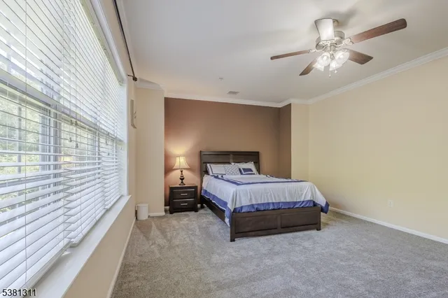 a spacious bedroom with a bed and a chandelier