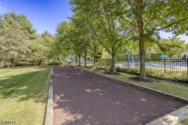 a view of a street with a large trees