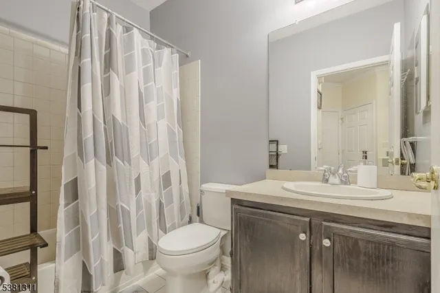a bathroom with a sink vanity mirror and toilet