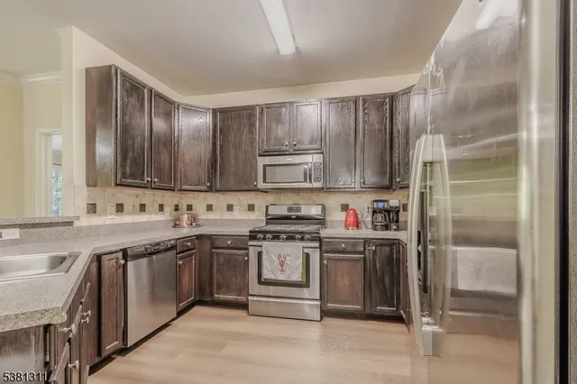 a kitchen with stainless steel appliances granite countertop a stove and a sink