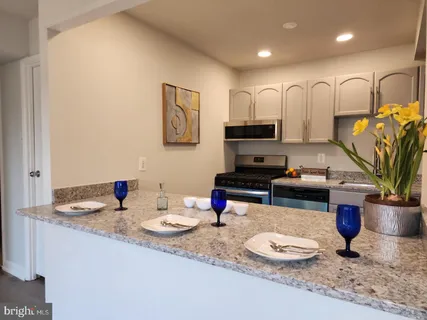a kitchen with a stove a sink and a refrigerator