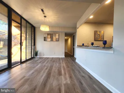 a view of a room with wooden floor and a window