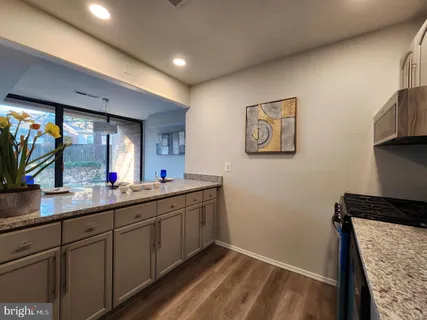a kitchen with a sink and a mirror