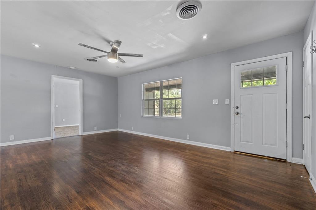2105 Fortview Road Austin, TX 78704 - Photo 5 of 37 Rich hardwood floors welcome you into this light-filled room, featuring recessed lighting and a ceiling fan for comfort.