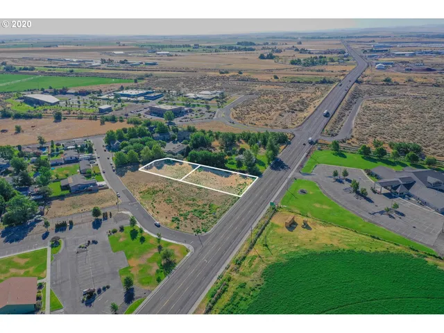 an aerial view of a house with a garden and mountain view