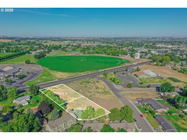 a view of a yard with wooden fence