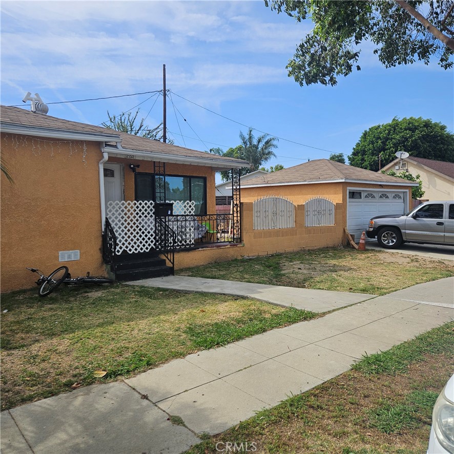 2153 Fitzgerald Avenue Commerce, CA 90040 - Photo 1 of 9 a front view of a house with a garden