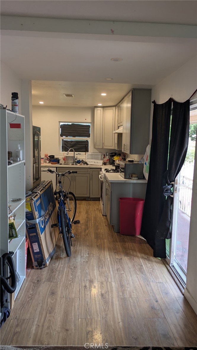 2153 Fitzgerald Avenue Commerce, CA 90040 - Photo 3 of 9 a kitchen with stainless steel appliances granite countertop a refrigerator stove top oven dining table and chairs