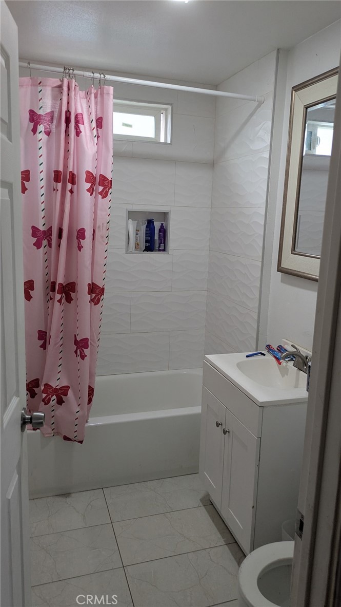 2153 Fitzgerald Avenue Commerce, CA 90040 - Photo 7 of 9 a bathroom with a sink a toilet and shower
