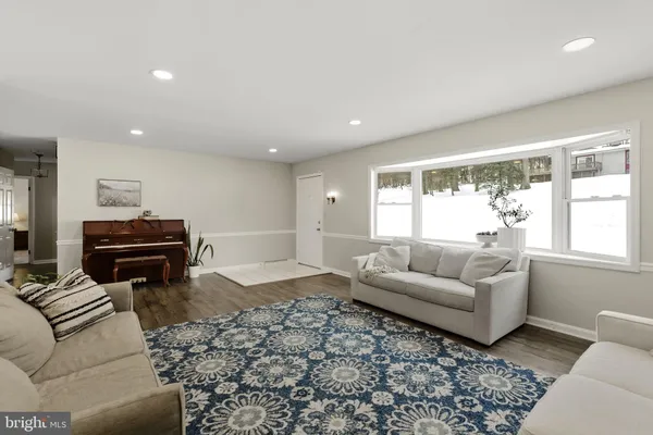 a kitchen with stainless steel appliances granite countertop a sink a stove a refrigerator cabinets and a dining table