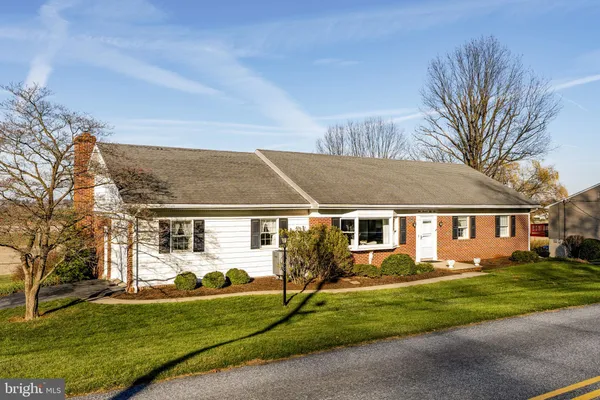 a front view of house with yard and green space