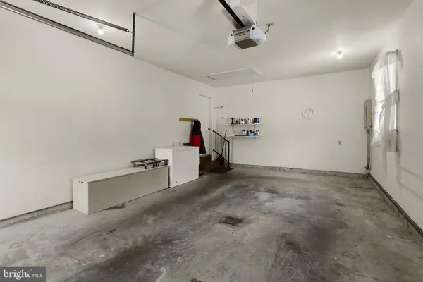 a kitchen with stainless steel appliances a stove and white cabinets