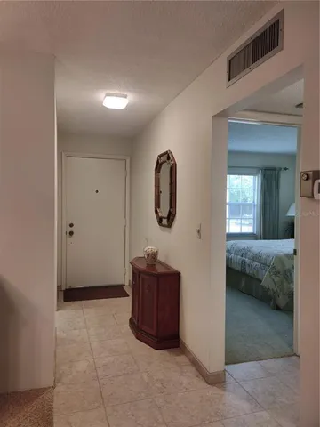a bedroom with a bed and a mirror
