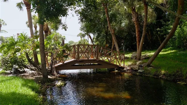 a view of swimming pool with outdoor space and trees in the background