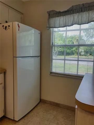 a white refrigerator freezer sitting in a kitchen