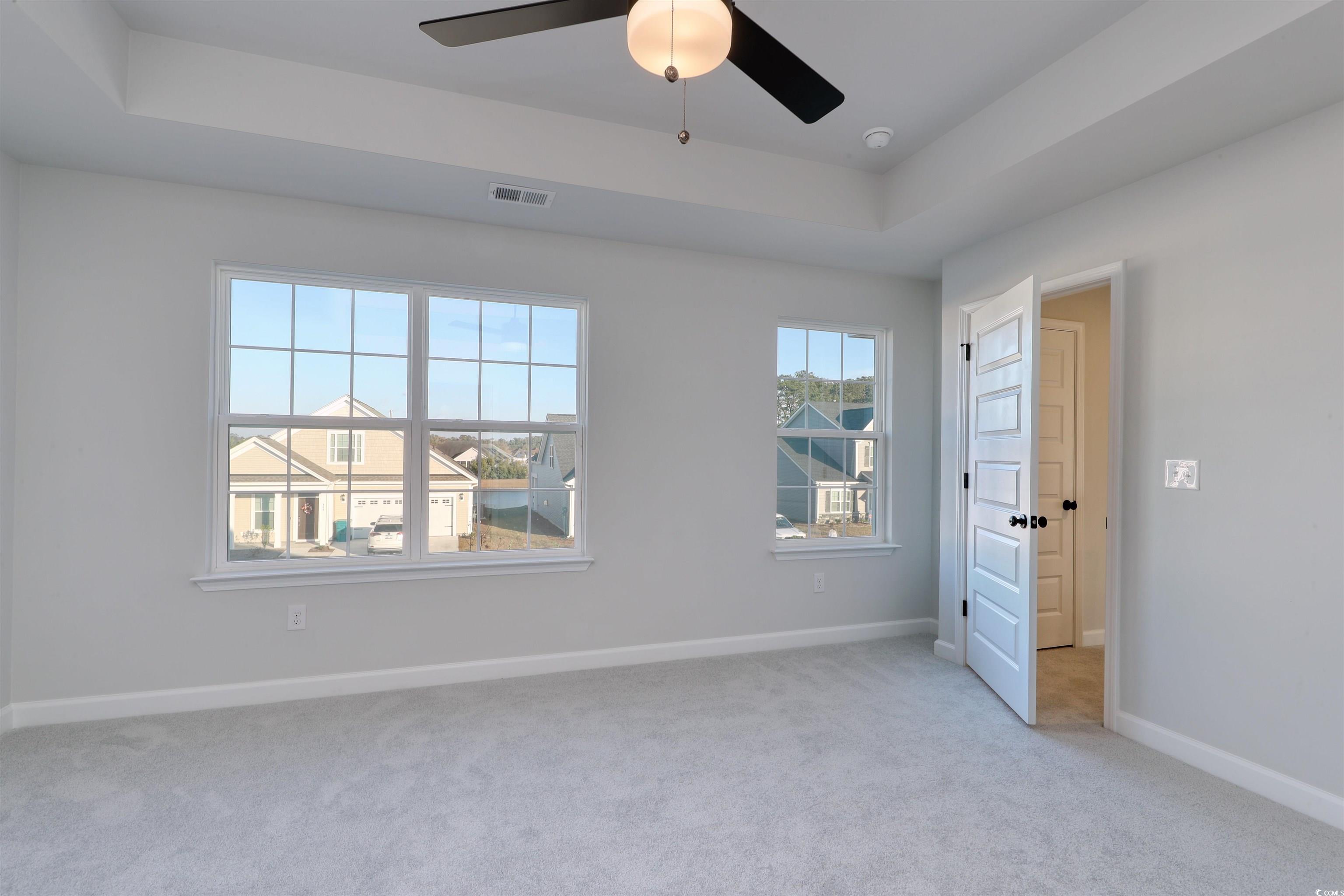 181 Azure Loop Myrtle Beach, SC 29588 - Photo 14 of 40 Carpeted spare room featuring a raised ceiling and