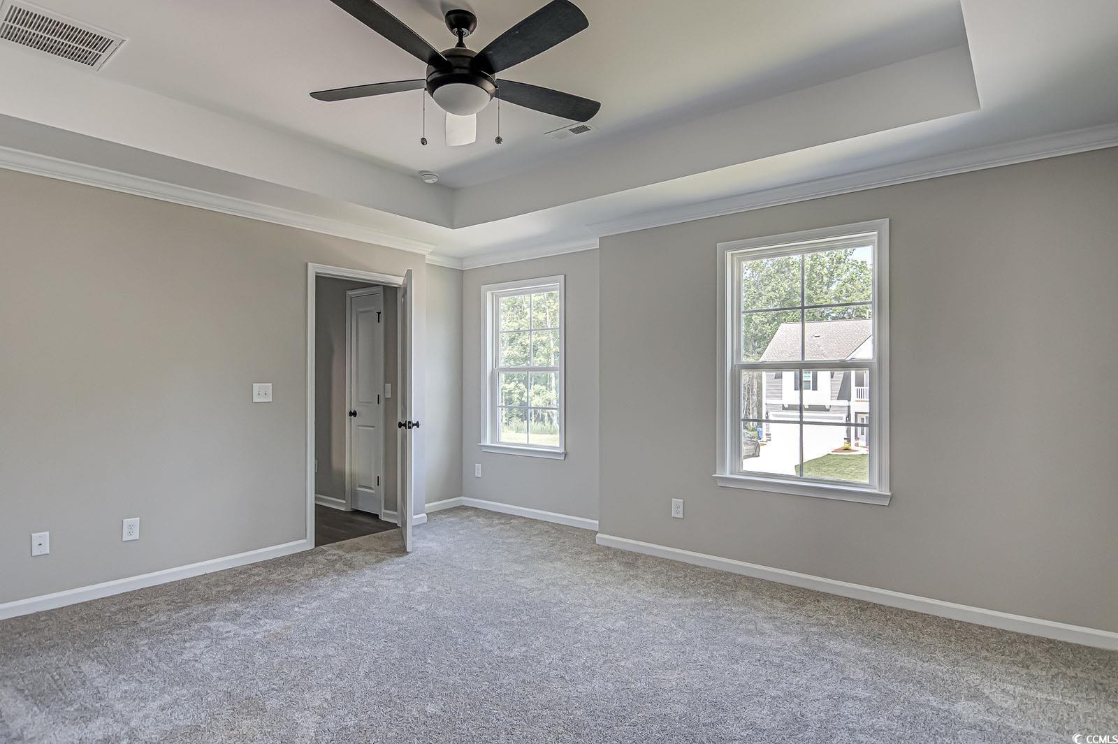 181 Azure Loop Myrtle Beach, SC 29588 - Photo 15 of 40 Carpeted spare room with a tray ceiling, ceiling f