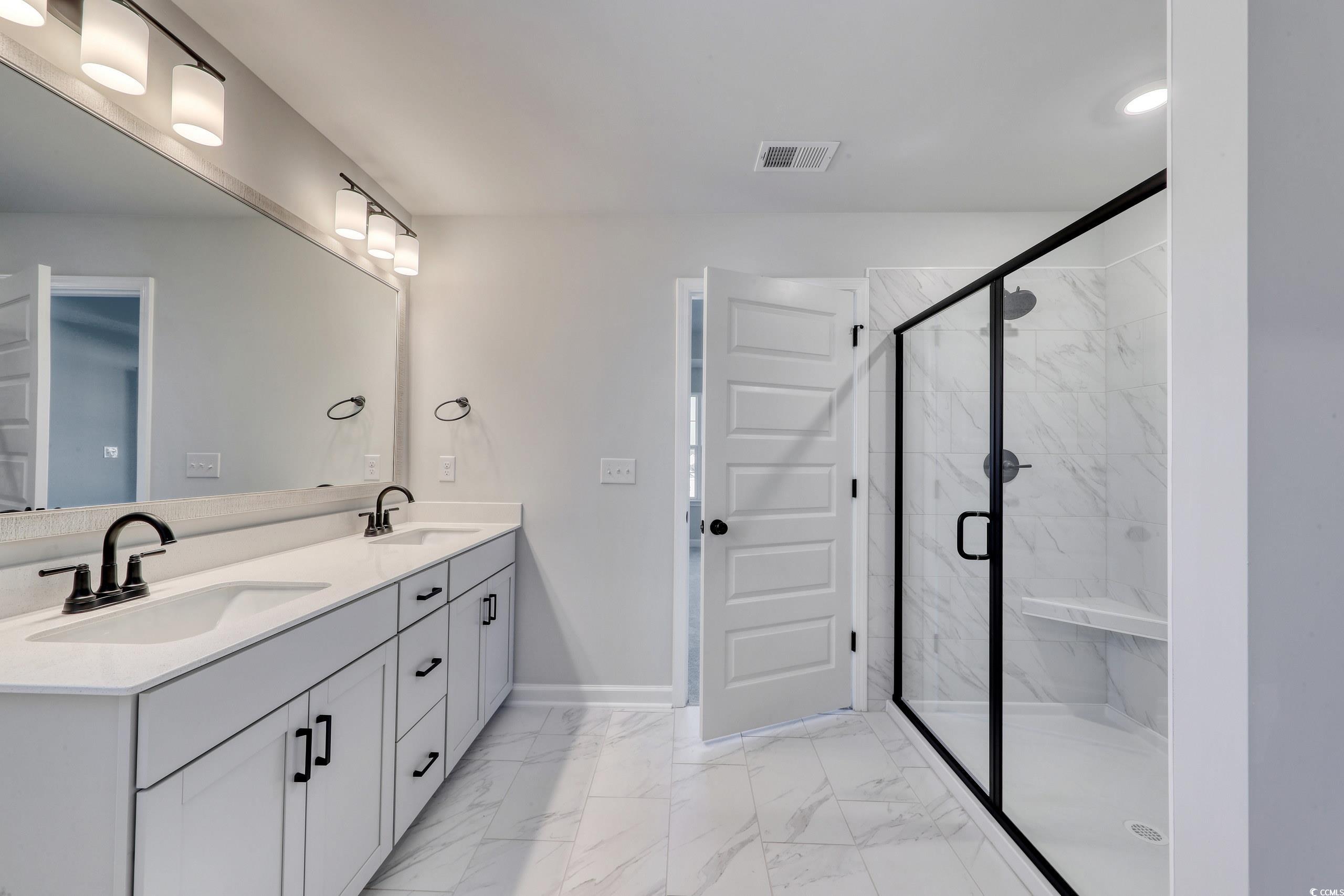 181 Azure Loop Myrtle Beach, SC 29588 - Photo 16 of 40 Bathroom featuring vanity and a shower with shower