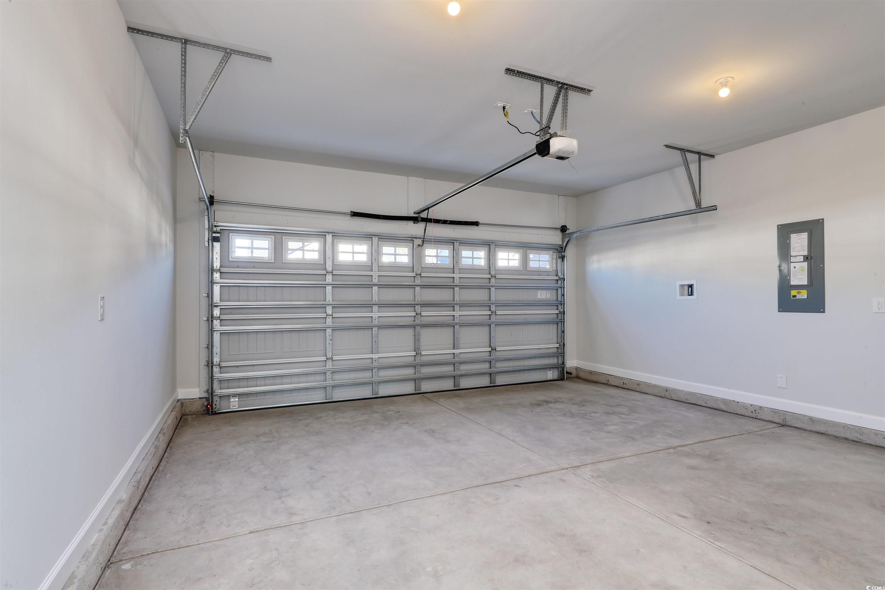 181 Azure Loop Myrtle Beach, SC 29588 - Photo 25 of 40 Garage featuring electric panel and a garage door