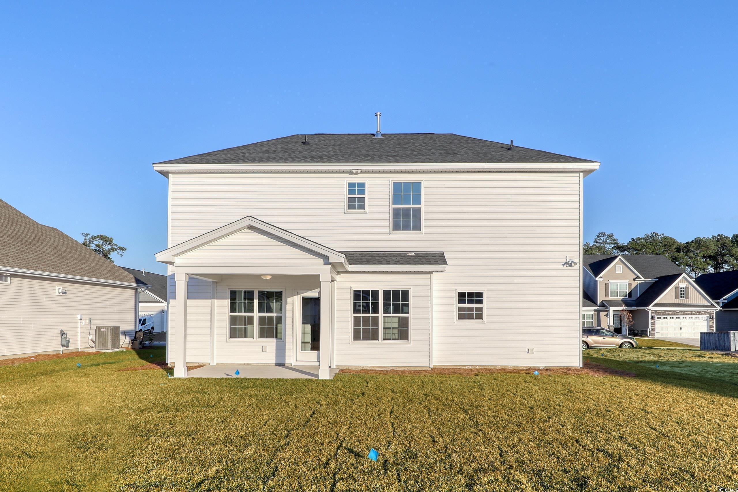 181 Azure Loop Myrtle Beach, SC 29588 - Photo 30 of 40 Back of house featuring a lawn, a patio area, and