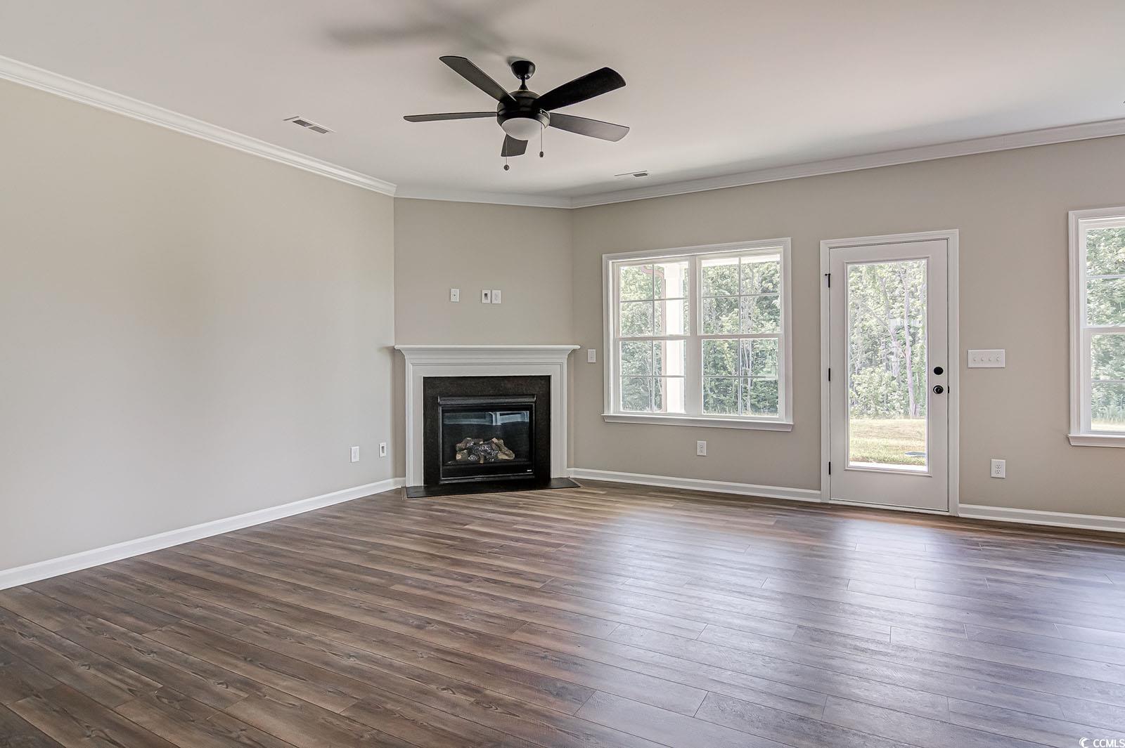 181 Azure Loop Myrtle Beach, SC 29588 - Photo 8 of 40 Unfurnished living room featuring crown molding, d