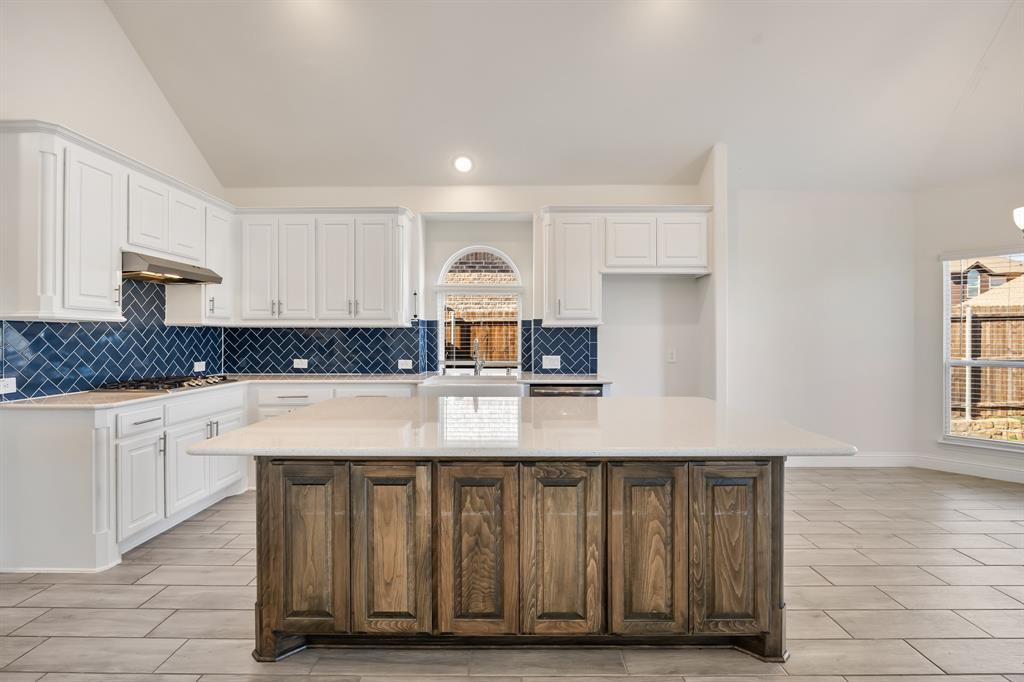 408 Piper Lane Fate, TX 75087 - Photo 12 of 40 Kitchen with tile backsplash and quartz countertops