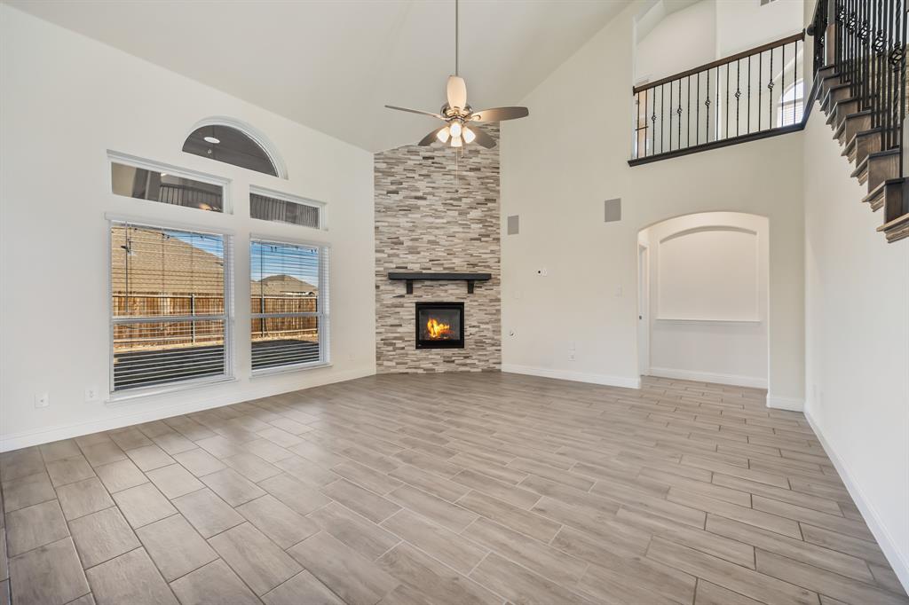 408 Piper Lane Fate, TX 75087 - Photo 9 of 40 Living room with gas fireplace